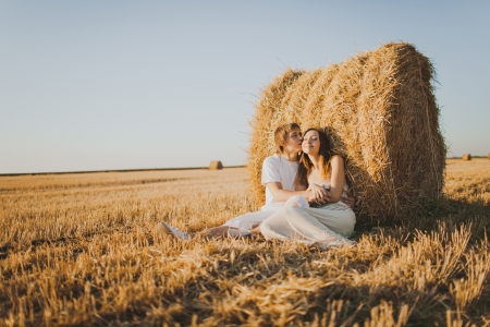 Image of young loving couple on wheat fieldの写真素材
