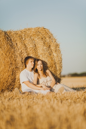 Image of young loving couple on wheat fieldの写真素材