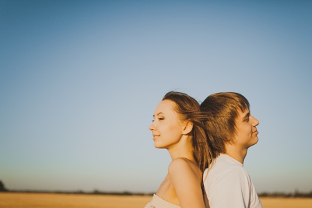 Image of young man and woman in wheat fieldの写真素材