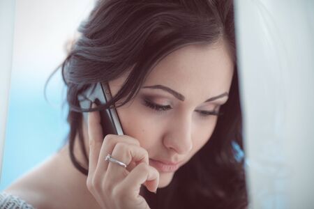 sensual woman with phone closeupの写真素材