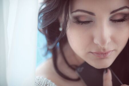 sensual woman with phone closeupの写真素材