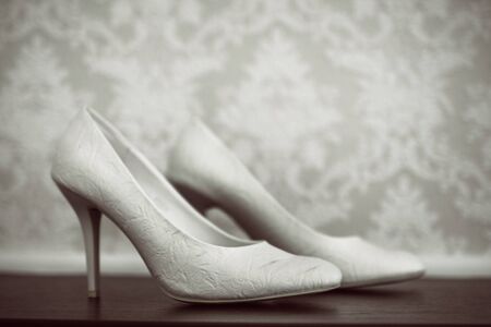 pair of bridal shoes on tableの写真素材