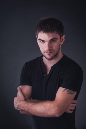 portrait of handsome guy on black backgroundの写真素材