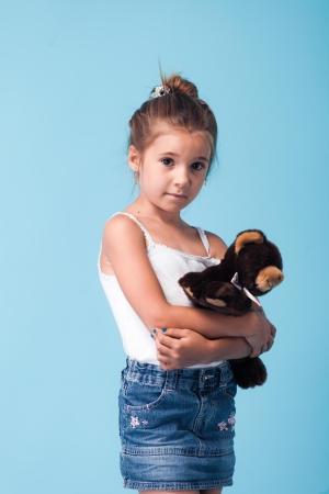 portrait of cute little girl on blue backgroundの写真素材