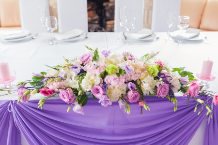 Celebratory tables in the banquet hall decorated with flowersの写真素材