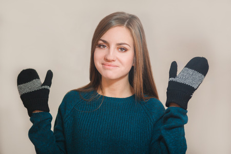 Beautiful woman wearing winter gloves on grey backgroundの写真素材