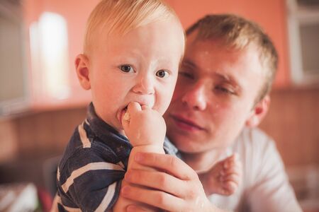 Happy father and son cooking at kitchenの写真素材