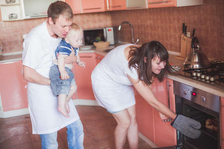 Happy family at kitchen with homemade pie