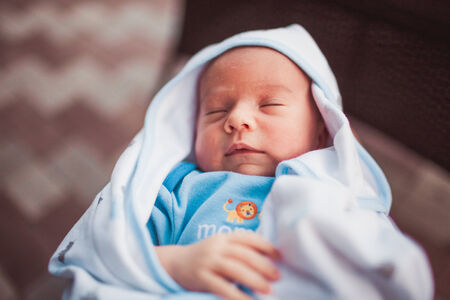 Sweet newborn baby sleeping in blanket outdoorの写真素材