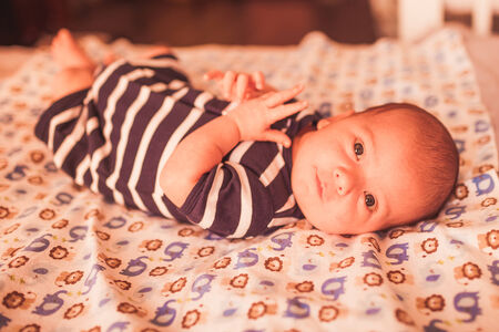 Portrait of cute little baby on blanket