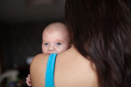 Young mother holding newborn babyの写真素材