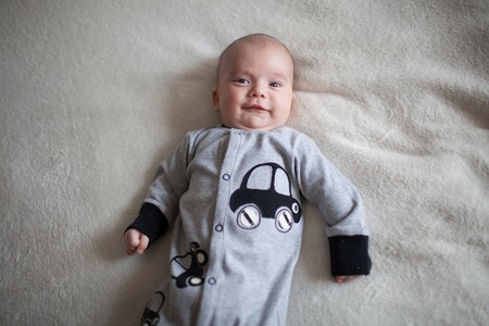 Portrait of cute little baby on blanket