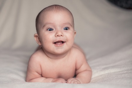 Portrait of cute little baby on blanketの写真素材