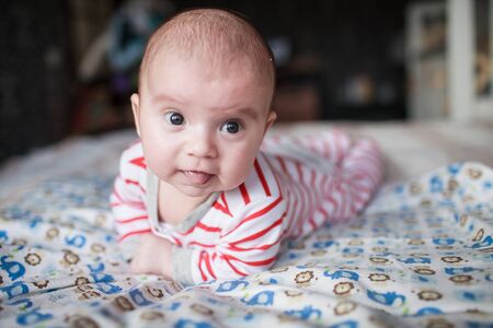 Portrait of cute little baby on blanketの写真素材