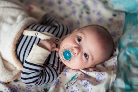 Portrait of cute little baby on blanketの写真素材
