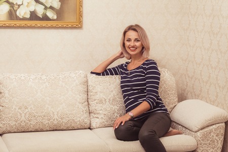 Portrait of pretty blond woman indoorの写真素材