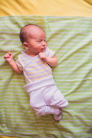 newborn little baby boy sleeping on blanket