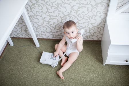 Cute baby boy talking telephoneの写真素材
