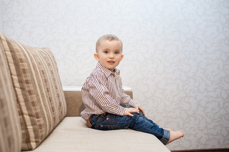 Cute baby boy on couchの写真素材