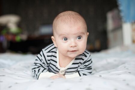 Portrait of cute little baby on blanketの写真素材