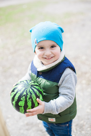 Little boy with ball on playgroundの写真素材