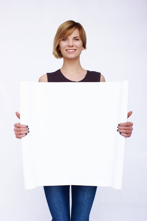 Happy woman holding board on isolated backgroundの写真素材