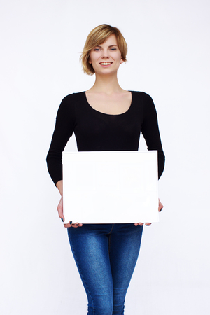 Happy woman holding board on isolated backgroundの写真素材