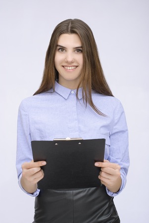 Portrait of businesswoman with tablet posing on isolated backgroundの写真素材