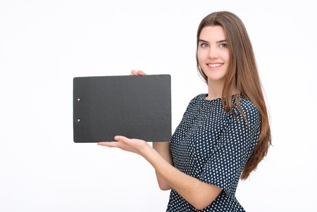 Happy woman in dress holding copyspace or showing somethingの写真素材