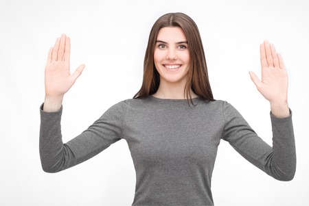 Portrait of gesturing woman in grey dressの写真素材