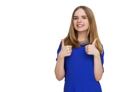 Portrait of woman in blue dress with thumbs upの写真素材