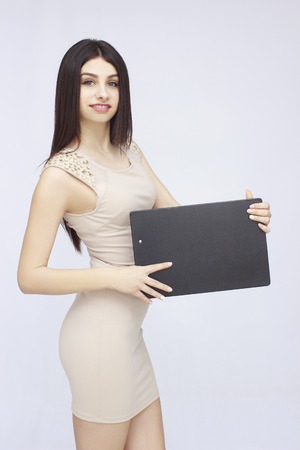 Portrait of woman holding board or cope space in handsの写真素材