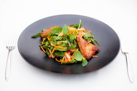 delicious vegetable salad with chicken on white backgroundの写真素材