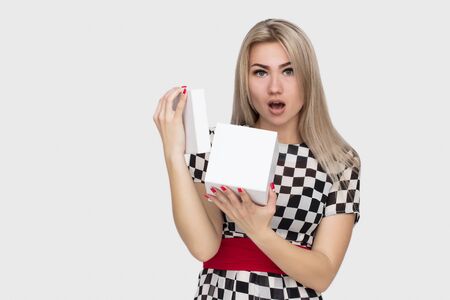 Young woman portrait opening gift on isolated background