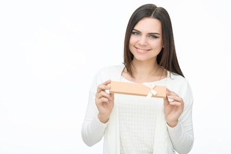 Present. woman in white dress holding presentの写真素材