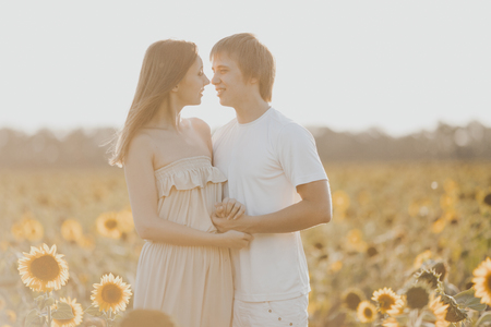 Young loving couple in fieldの写真素材