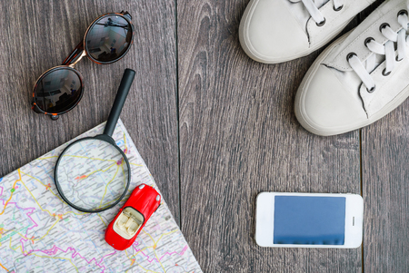 Outfit of traveler or student. Overhead of essentials for modern young person. Different objects on wooden background.の写真素材