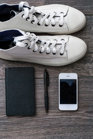 Outfit of traveler or student. Overhead of essentials for modern young person. Different objects on wooden background.の写真素材