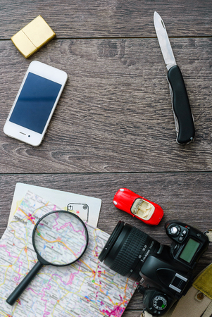 Outfit of traveler or student. Overhead of essentials for modern young person. Different objects on wooden background.の写真素材