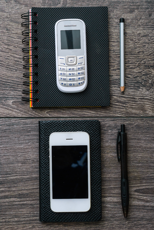 Close up view of school supplies and mobile phone on top of the wooden tableの写真素材