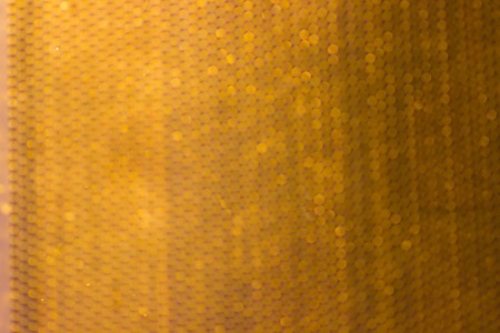 Blurred golden metal grid or grate backgroundの写真素材