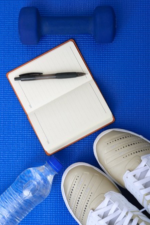 Flat lay shot of Sport equipment on yoga mat. Equipment for jogging, yoga, stretching, pilatesの写真素材
