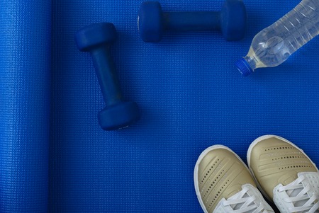 Flat lay shot of Sport equipment on yoga mat. Equipment for jogging, yoga, stretching, pilatesの写真素材