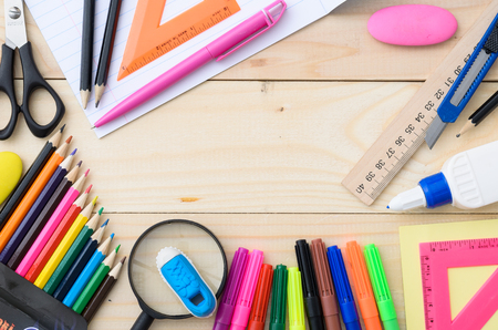 School stationery with notebook copyspace on wooden boardの写真素材