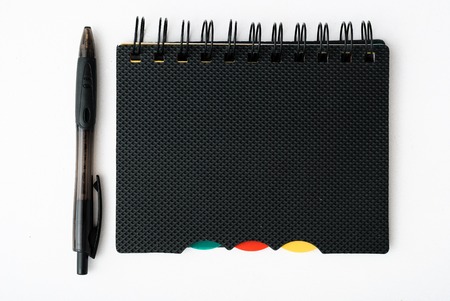 notepad with pen isolated on white backgroundの写真素材