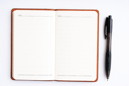notepad with black pen isolated on whiteの写真素材