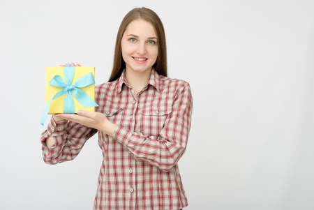 Young woman portrait holding giftの写真素材