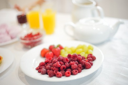 Bowl with berries on the table in kitchen