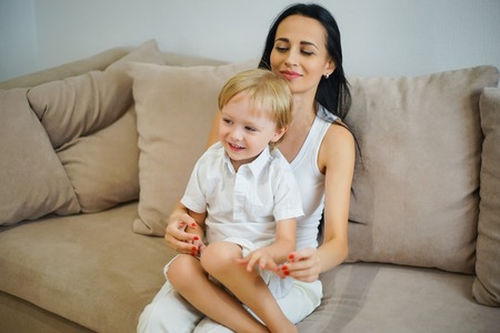 Closeup of happy mother and son playing at home. Weekend family leisure time concept.の写真素材
