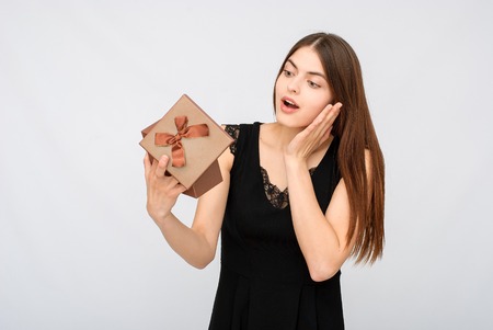 Present. woman in black dress holding giftの写真素材
